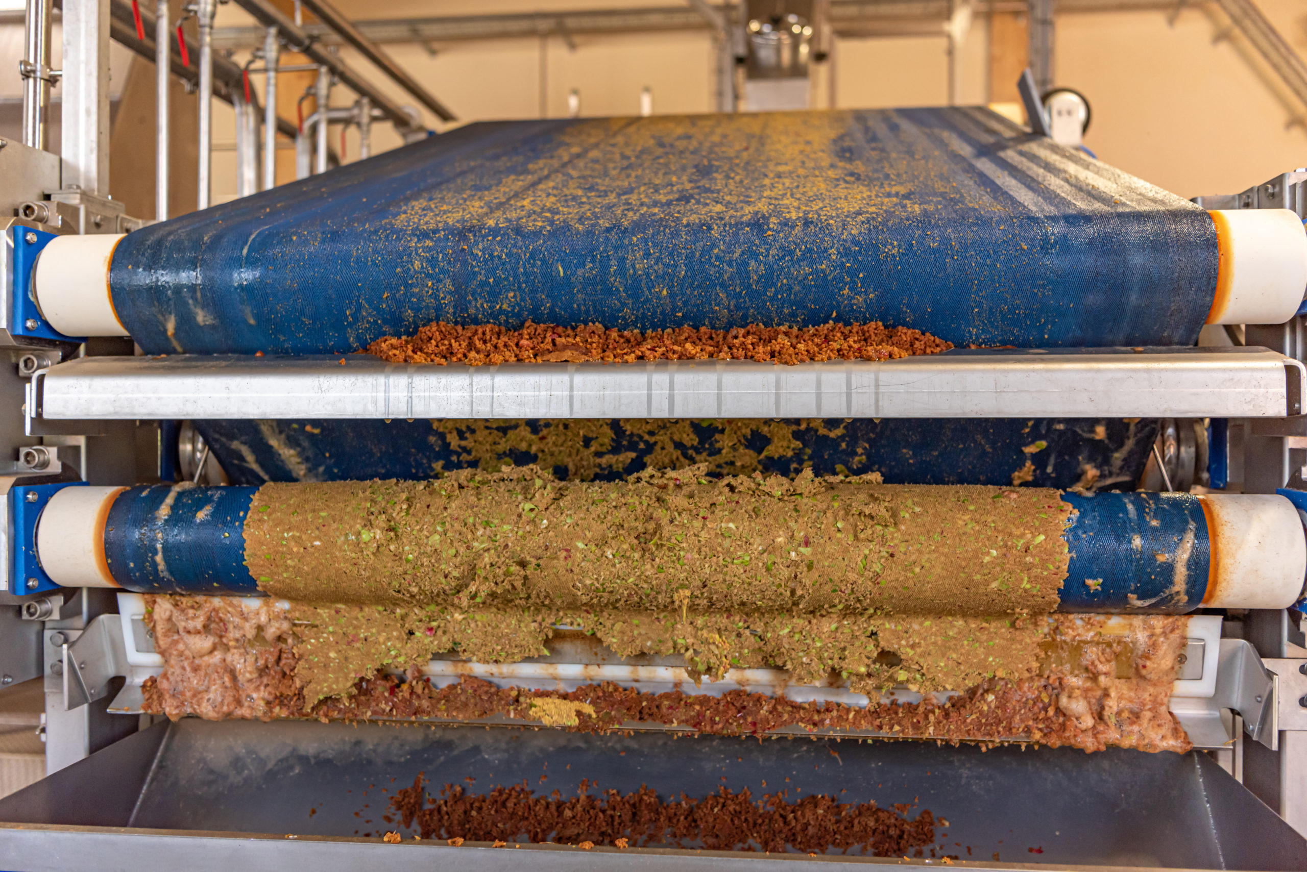 Modern Machine squeezes apples and apple pomace remain as press residues