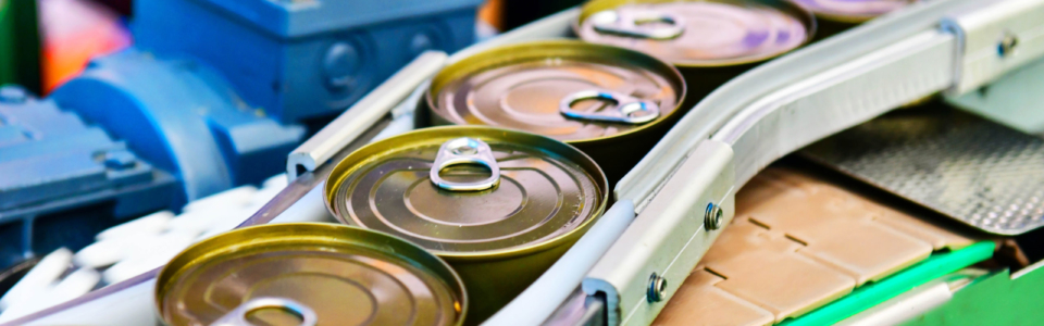 Canned food products on conveyor belt in distribution warehouse. parcels transportation system concept