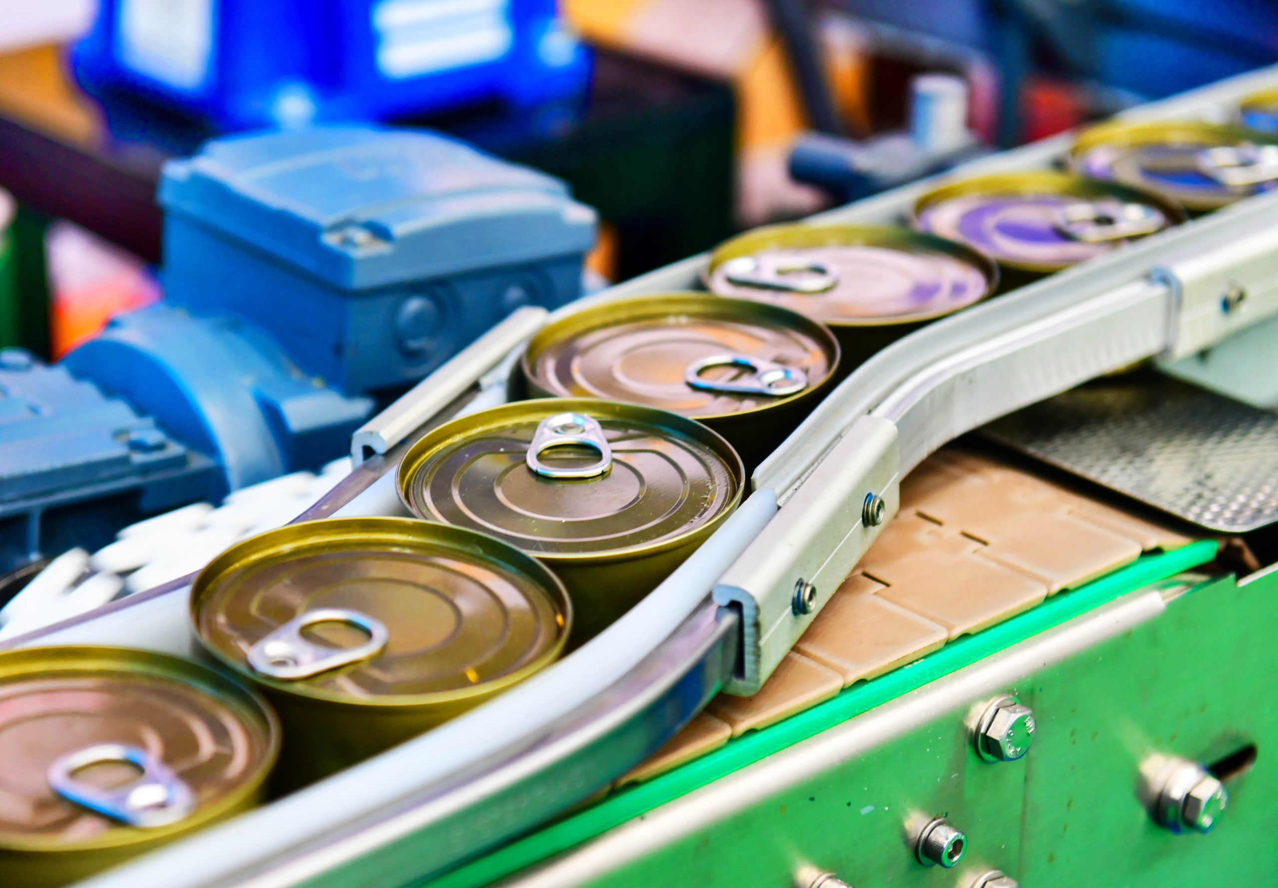 Canned food products on conveyor belt in distribution warehouse. parcels transportation system concept